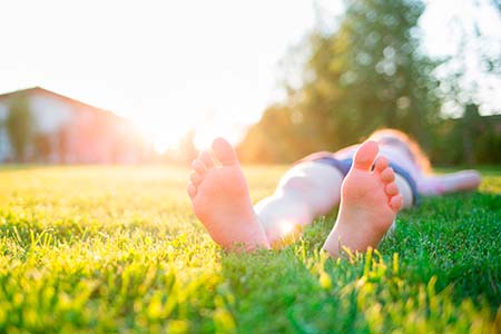 man lying on the lawn. feet close-up. outdoor rest on a summer d